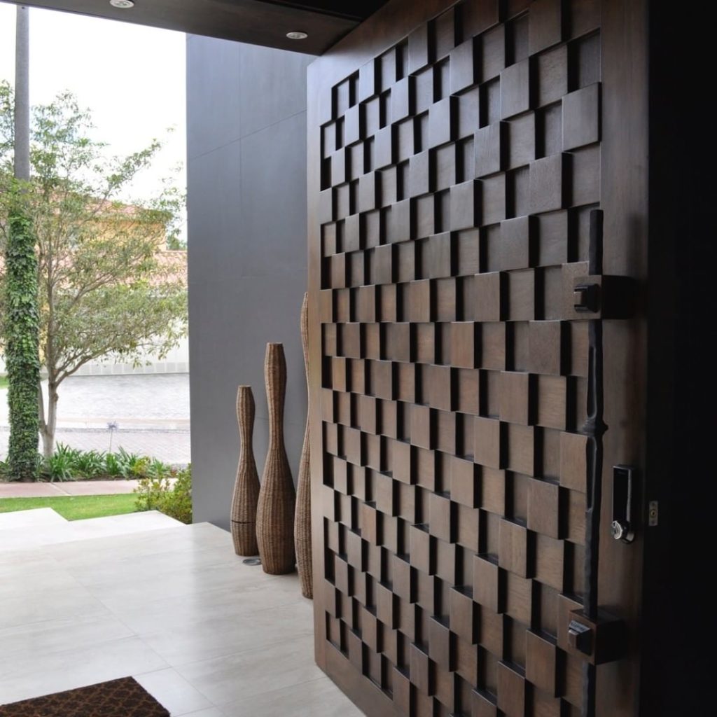 Custom wood door showcases a design of interweaving cubes. 